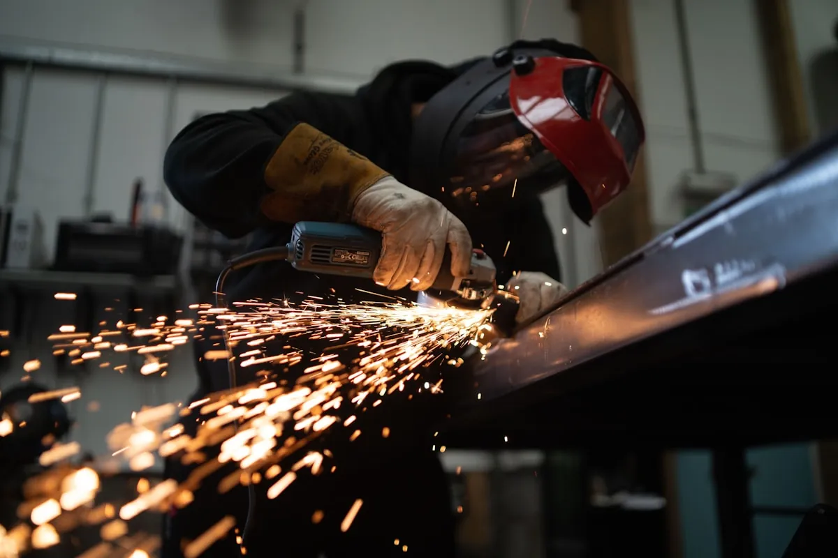 Angle grinder dressing a finished weld