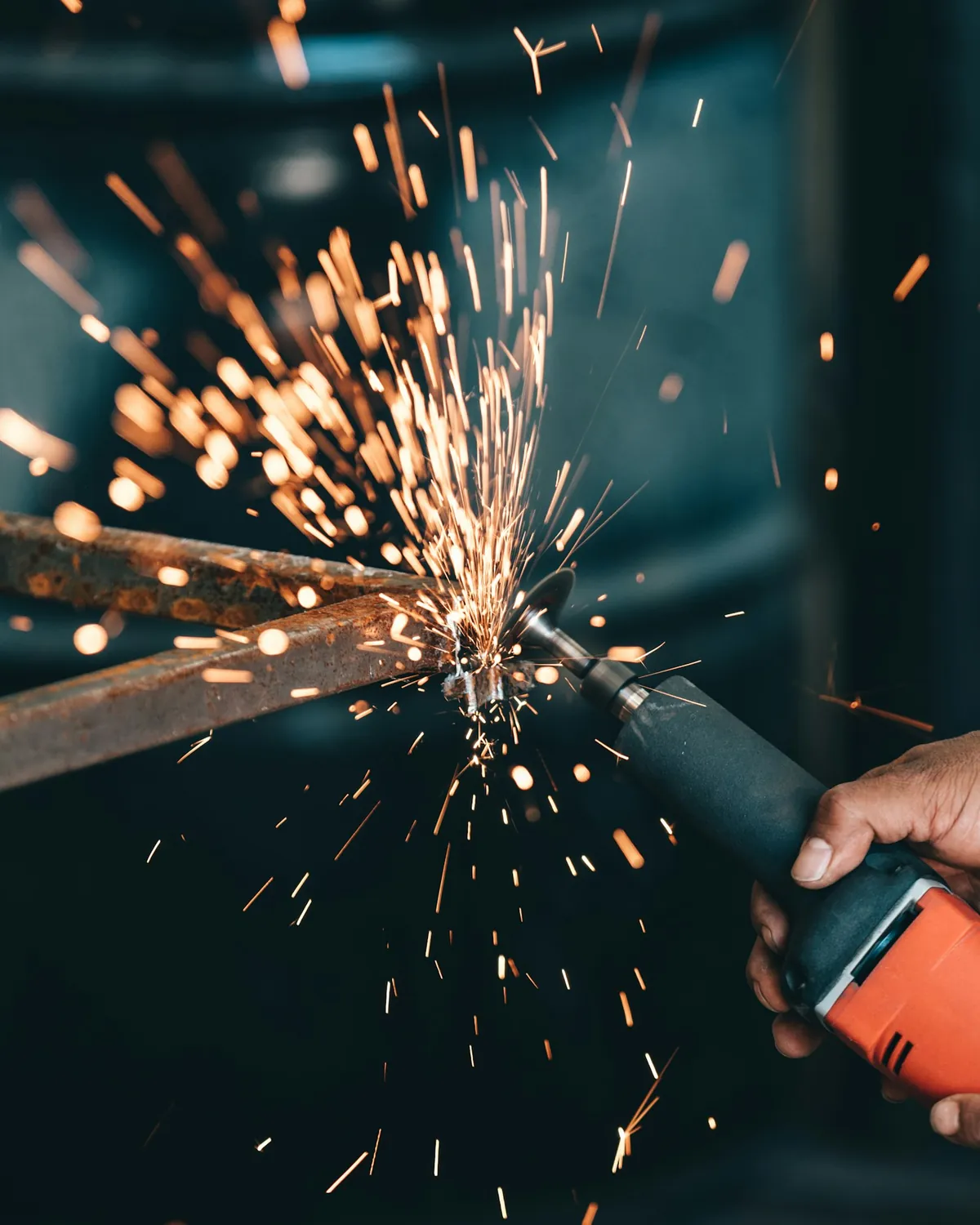 Grinding a weld flush, spark fan across the frame