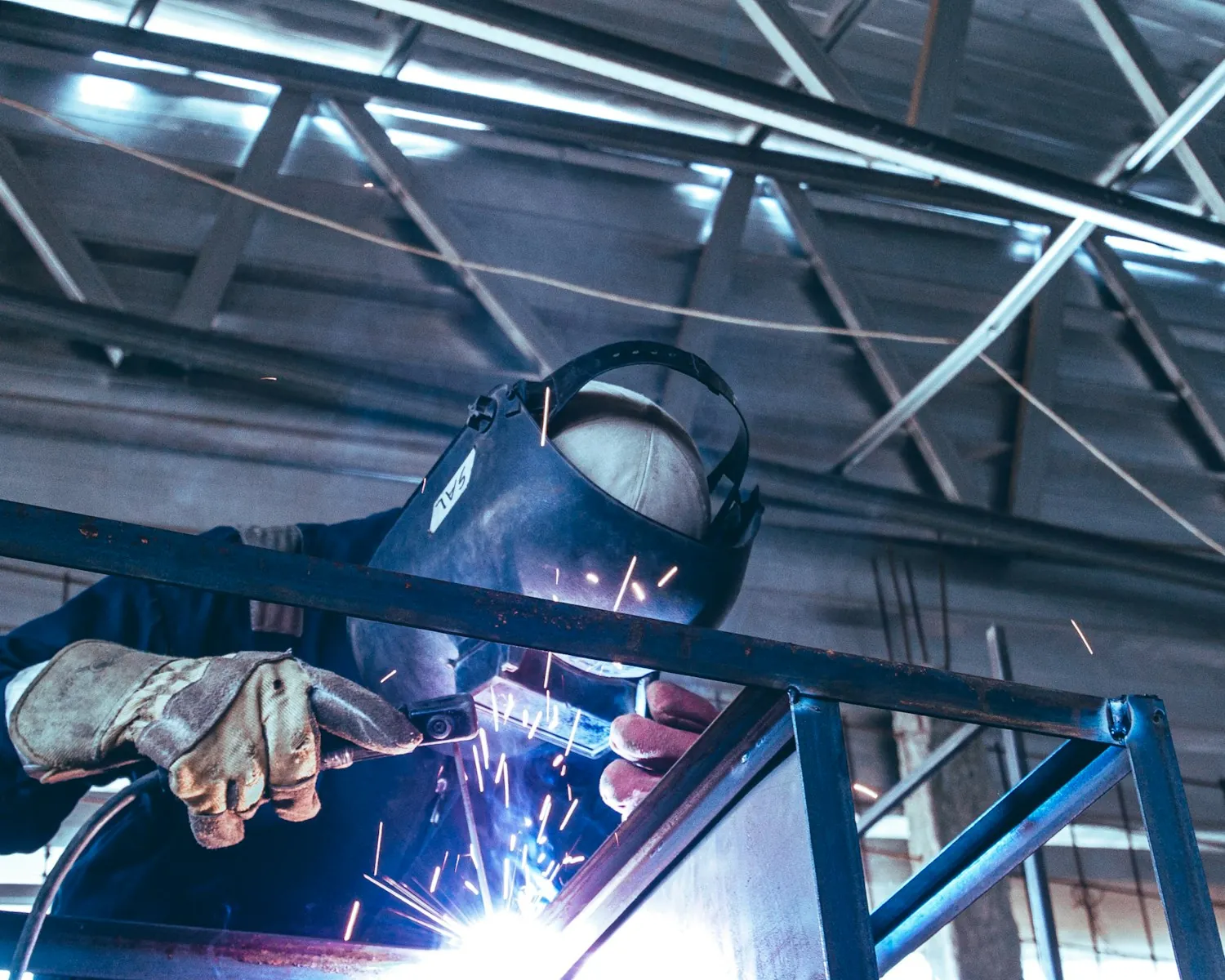 Welding structural steel overhead on a job site
